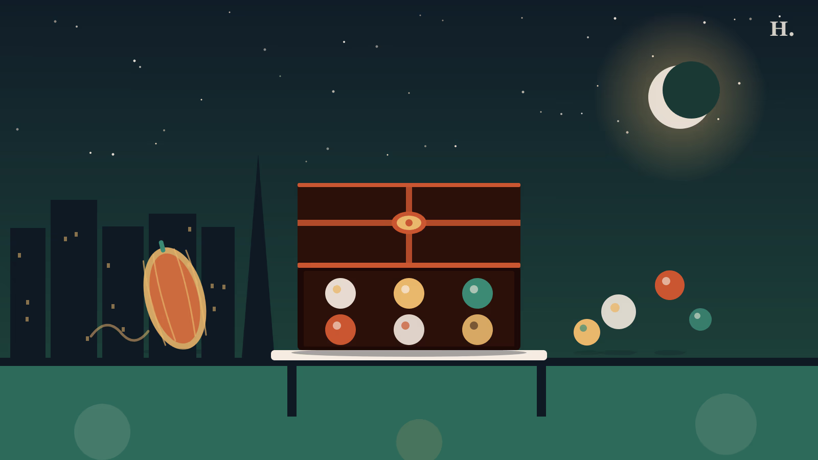 Best chocolate shops in Houston: open gift box of bonbons with a golden cacao pod at night