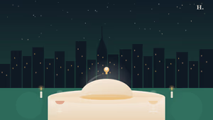 Hotel restaurant serving cloche and wine glasses against the Houston night skyline