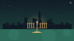 Hanukkah in Houston: lit menorah in the foreground against the downtown Houston night skyline