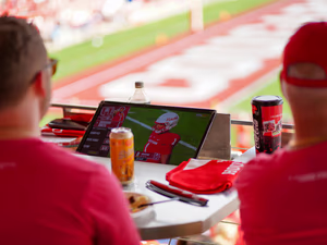 A photo of two people watching a UH game