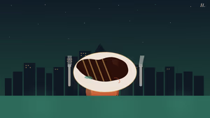 Grilled steak on a round plate with knife and fork, downtown Houston skyline at night